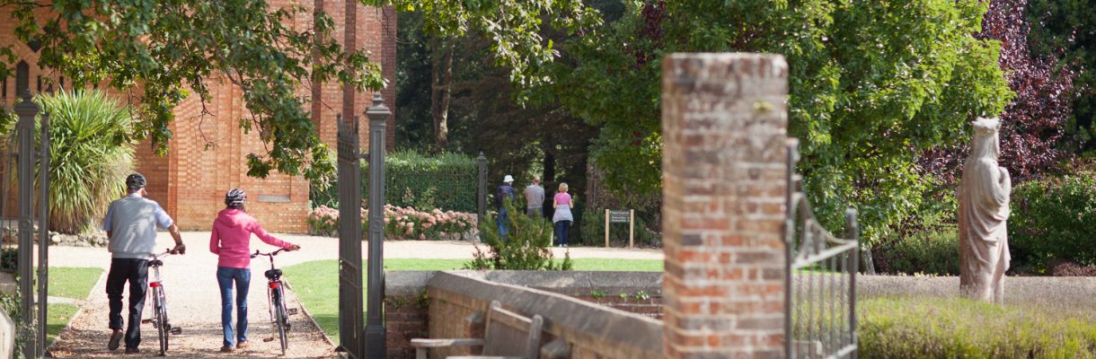 Couple walking bikes at Quarr Abbey